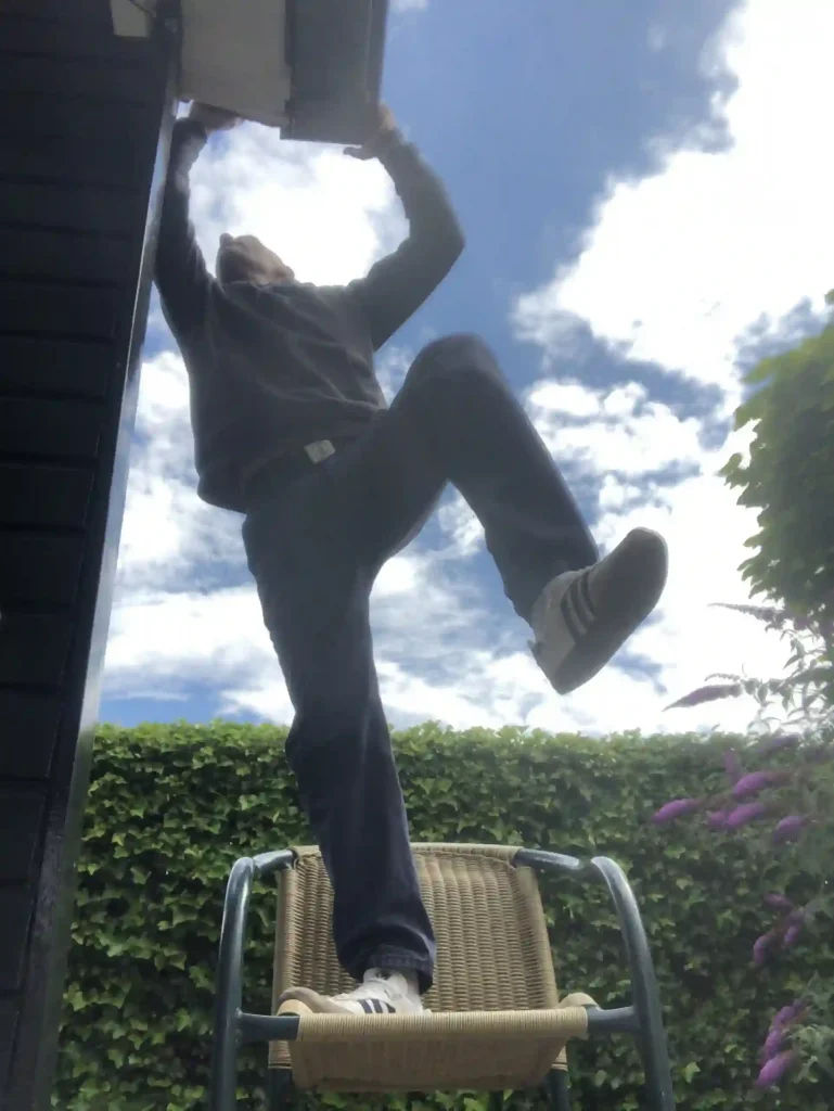 locksmith climbing a roof